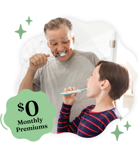A smiling man and a young boy brushing their teeth together, framed in a wavy shape with green stars and a green badge reading '$0 Monthly Premiums'.